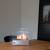 Hippe biohaard met rond glas en een stalen brander. Brandtijd 2-3 uur. Maat H: 28 x B: 35 x D: 12 cm.